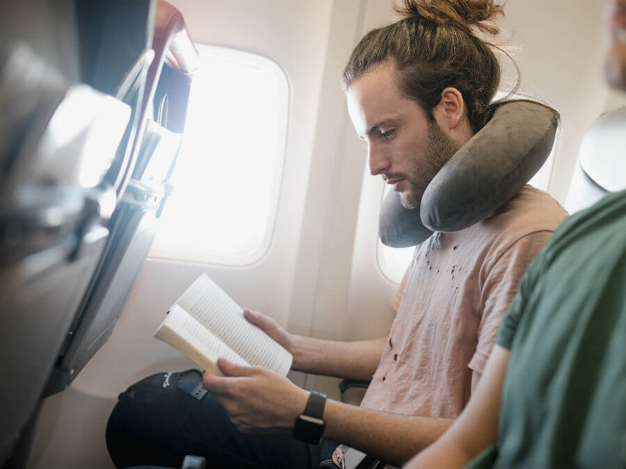 Man reading on a flight