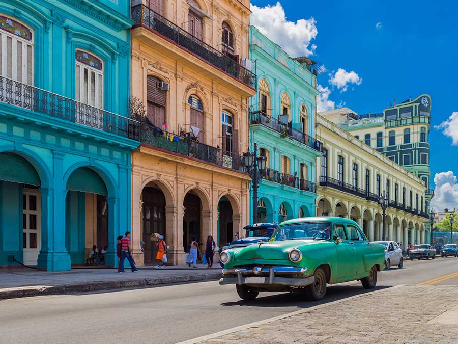 Colourful buildings and a vintage car in Havana, Cuba