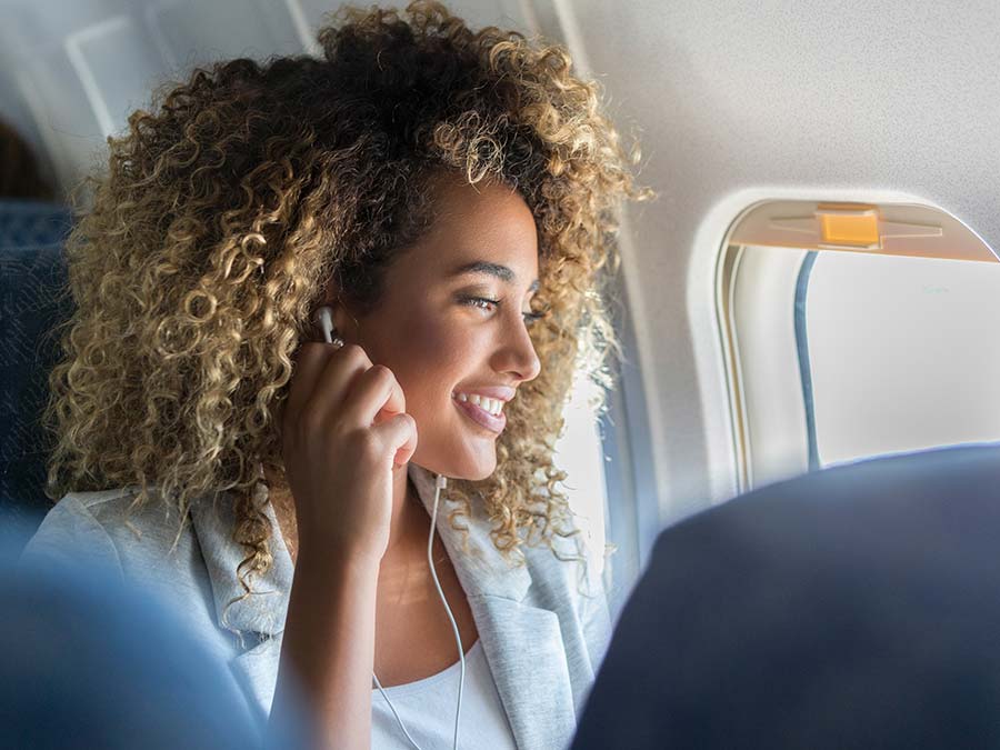 Woman listening to music on flight