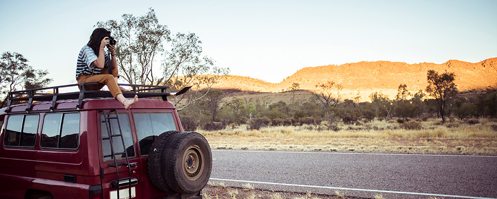 Taking photo from car roof in Australian outback