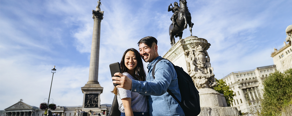 Couple taking selfie in front of landmarks