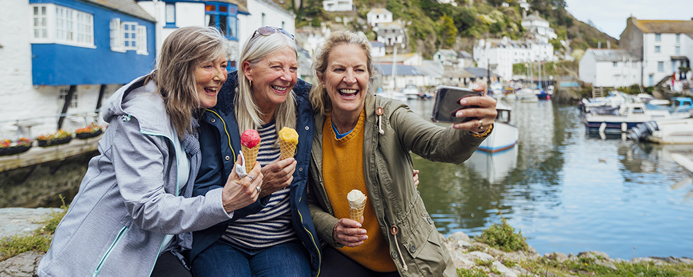 group of seniors eating ice cream and taking selfie